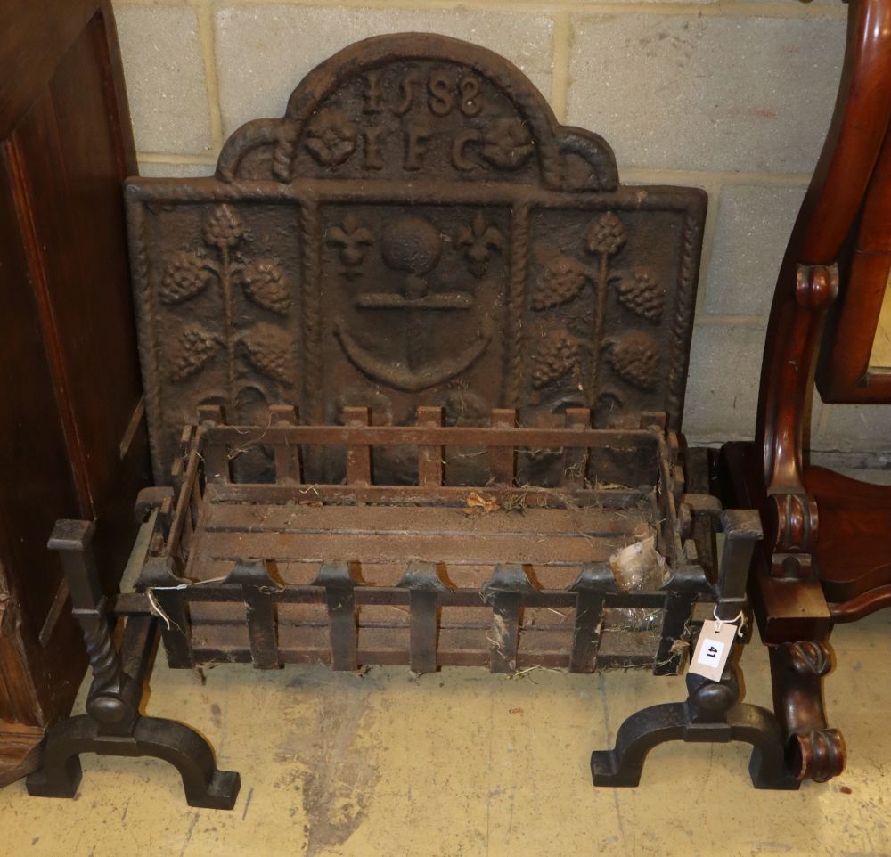 A cast iron fireback, W.78cm, H.68cm, a wrought iron basket grate and a pair of wrythen fire dogs
